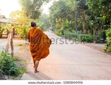 Buddha monk walking in the morning to receive food from Buddhism.