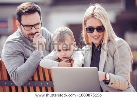 Family watching cartoon outdoors,having fun.