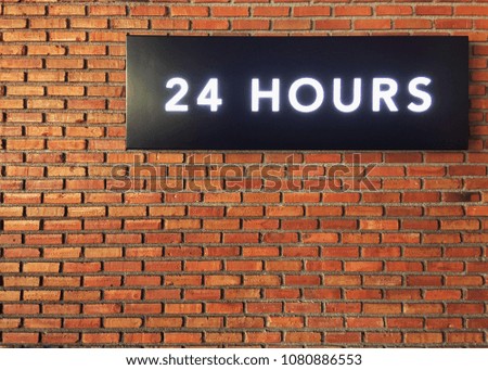 sign with 24 hours text on wall