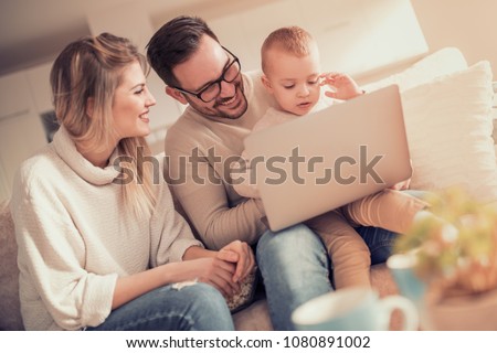 Young family watching cartoon on laptop together.People,family,love and happiness concept.
