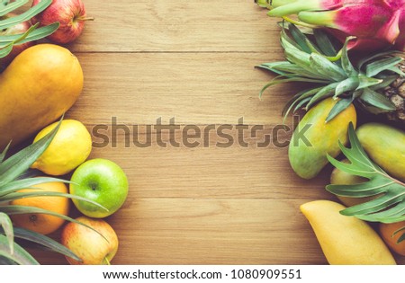 Group of fruits on wood table with space background