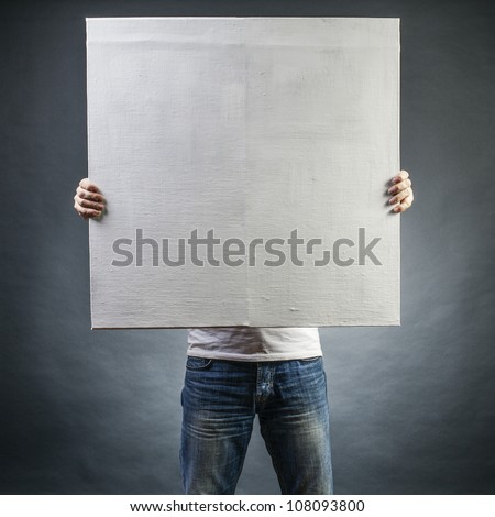 male holds a square canvas primed Royalty-Free Stock Photo #108093800