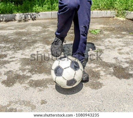 Man plays a soccer ball in nature in the city