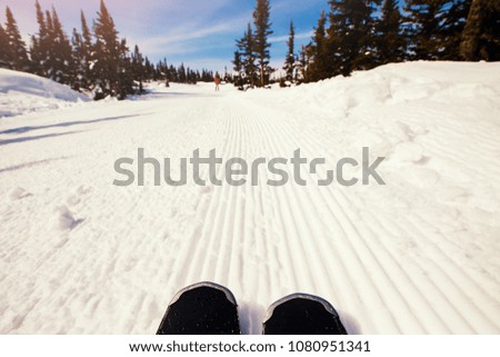 Close-up of skiing on background of descent from mountain along route