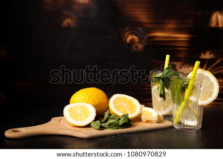 Refreshing lemonade made of fresh lemons on vintage wooden background