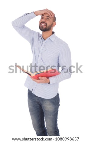 Student holding a book and he remembered something he didn't write it on the exam so he hit his forehead with his hand, isolated on white background