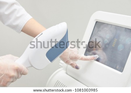 Modern equipment. Laser hair removal. Personal care. Light background.