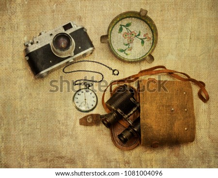 Retro things: a camera, an ashtray, pocket watches, binoculars in a case