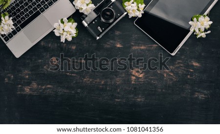Camera and Laptop. On a wooden background. Top view. Copy space.