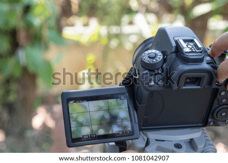 Thailand-April 15, 2018: Black DSLR Camera for Photographers using camera located on tripod to take pictures of online shopping for sale on web site microstock