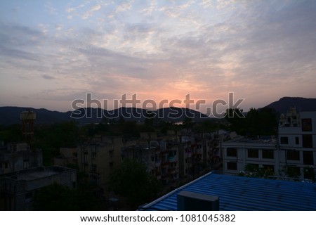 The top view of Jaipur city during the sunrise with a beautiful background of mountain and sky with clouds. 