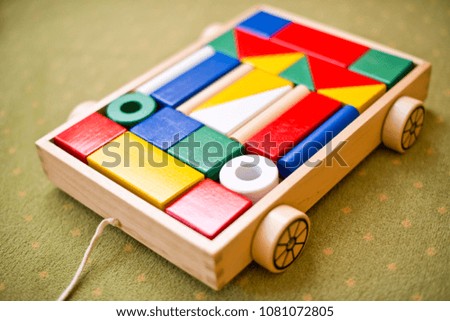 A wooden toy for a child, a toy car with wooden blocks for children.