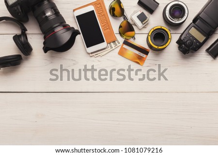 Photo equipment. Top view of diverse personal equipment for photographer or creative designer on white wooden table, copy space