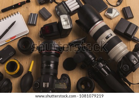 Photo equipment. Top view of diverse personal equipment for photographer or creative designer on wooden table, copy space
