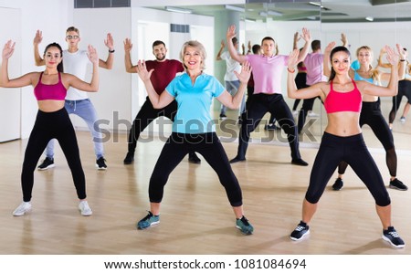  Happy cheerful smiling slim athletic women and men  dancing strip plastic in class