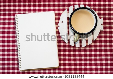 Rustic Mockup. Coffee, notebook and wooden fish  on a red & white textile