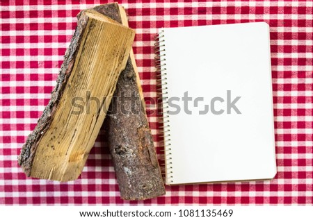 Rustic Mockup, notebook and logs on a red & white textile