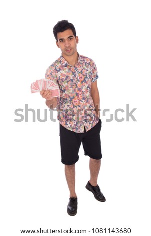 Full-length shot of a young man holding cards in hand and hand in pocket, isolated on a white background.