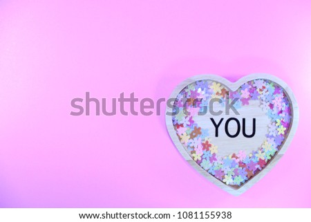 Wood heart of you with colorful flower on pink background