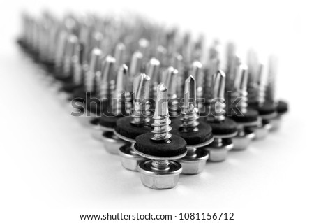 A column of inverted screws for fixing roofing sheets on a white background.