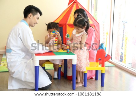 Large group of children write their homework and play toy activity at hospital with doctor and nurse for active develop iq.