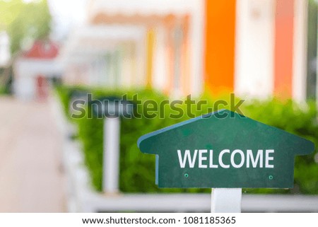 welcome sign in front of colorful home