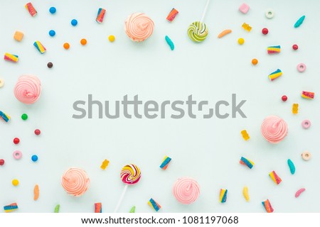 Colorful candies on pastel turquoise background. Flat lay, top view Royalty-Free Stock Photo #1081197068