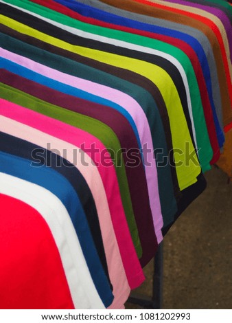 Colorful trousers are arranged neatly on the table
