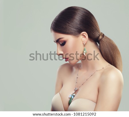Fashion Beauty Portrait of Cute Woman with Healthy Hair, Makeup and Jewelry