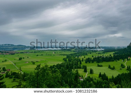 Landscape with clouds and trees and mountians in bavarian near the royal castles