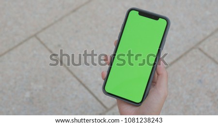 Female hand using mobile phone with chroma key