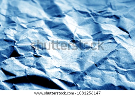 Old paper with wrinckles in navy blue color. Abstract background and texture for design.