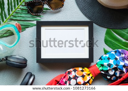summer object and accessories flat lay of copy space with sunglasses, modern photo frame and snorkel on gray leather background texture, summer colorful concept