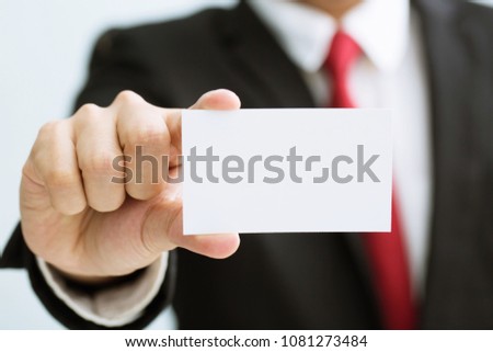 Young businessman who takes out blank business card from the pocket of his shirt business suit, copy space	