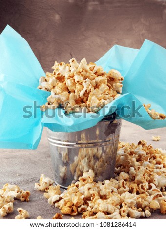 Salt popcorn or sweet popcorn on old grey background