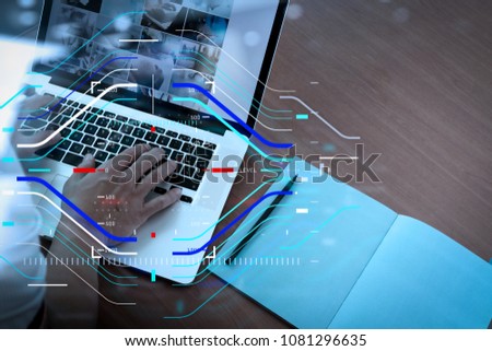 Concept of focus on target with digital diagram.top view of businessman hand working with new modern computer and smart phone and business strategy on wooden desk as concept