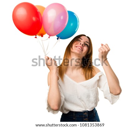Lucky beautiful young girl holding a balloon