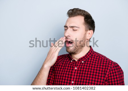 Portrait of sleepy tired passive clothed in casual red checkered shirt outfit he caugth a cold and wants to sneeze, isolated on gray background, copy-space
