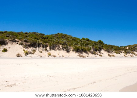 
Sweeping view of the soft white sandy beach and  Indian Ocean waves breaking on  Hutt's Beach near Bunbury Western Australia on an  early summer afternoon is cool and inviting.