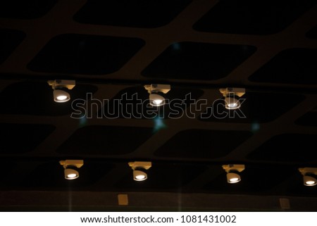 Modern conceptual high tech black ceiling with light sources.