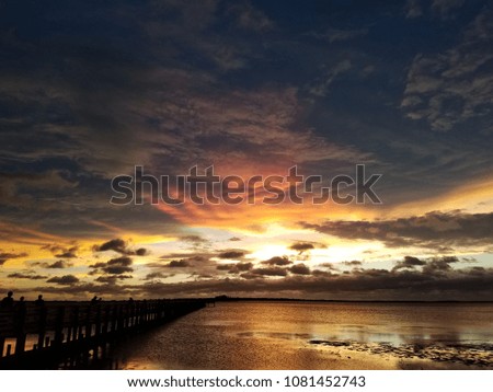 Dark clouds over the water with sunset horizon