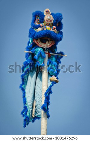 Lion dance show in the festival procession Thailand. Show on bamboo pole