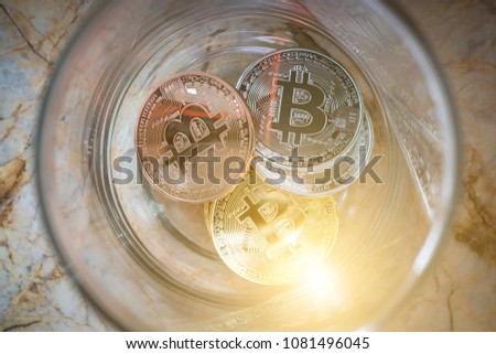 Top view of a dozen coins, Alternative investment in bit coin, Investor may learn saving money from coins, A studio photo of a money jar.