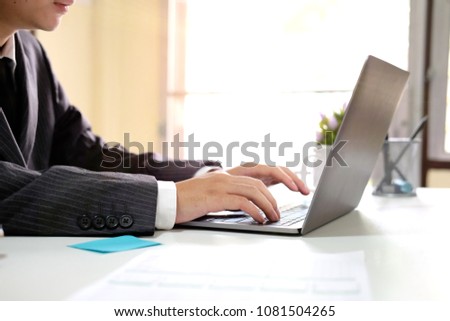 Businessman working with computer laptop with lighting morning and side view photo.