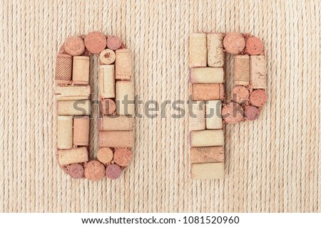 Alphabet letter O and P made of wine corks on jute rope background