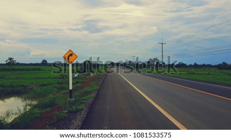 Traffic Signs with the road in the forest and the sky