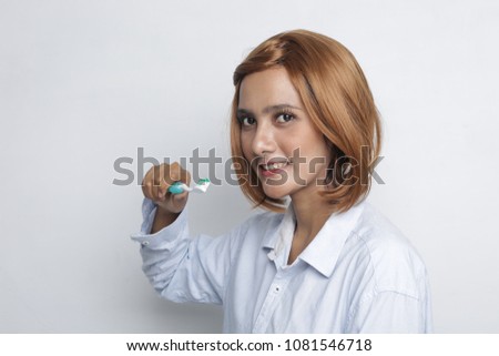 asian woman tooth brush isolated. Happy young woman brushing teeth.