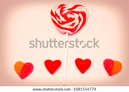 heart lollipop with heart candies on colorful background