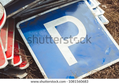 the old road sign lies on the dump