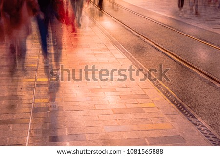 Blurred image of man people walking on road with railway